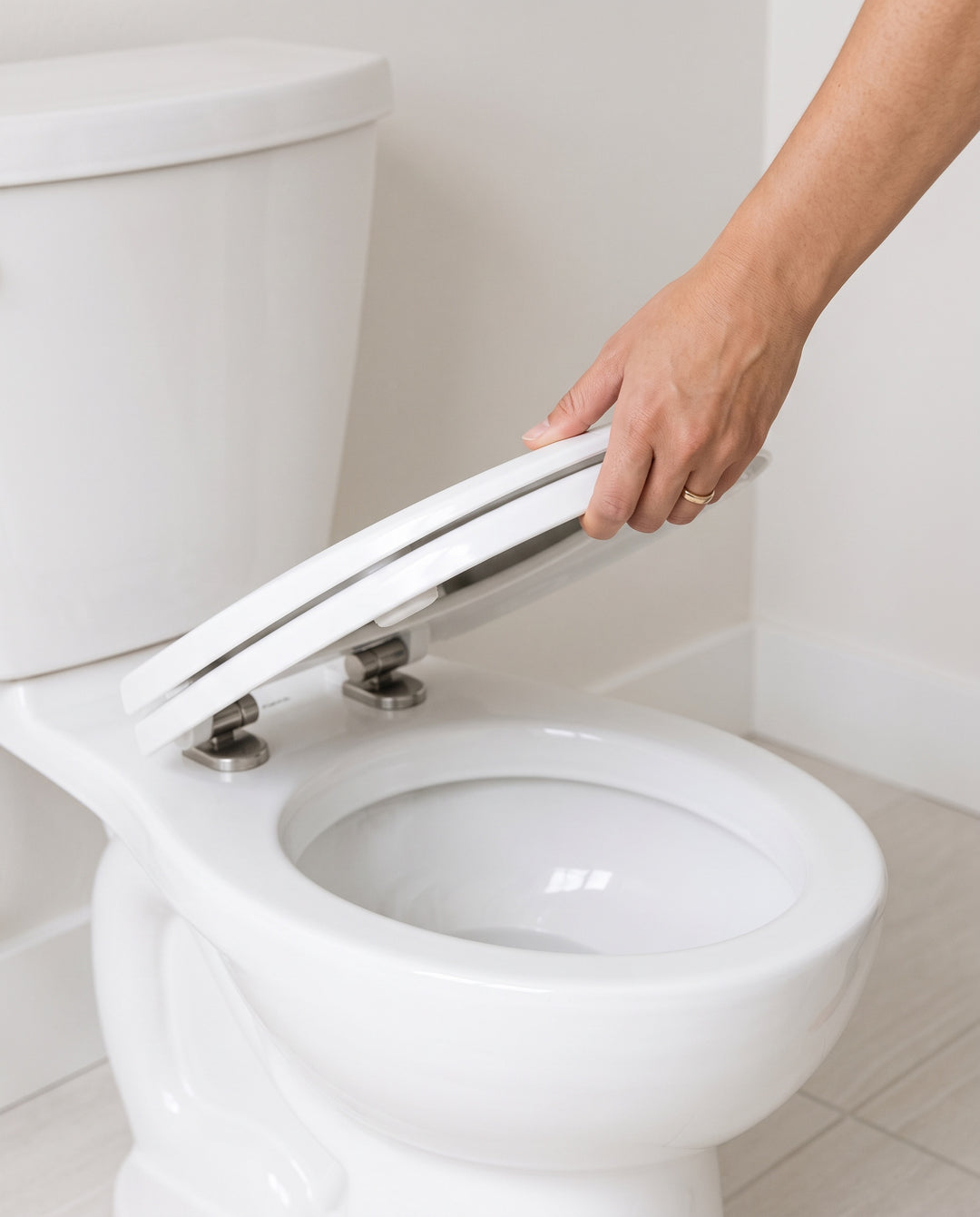 Step one: lifting the existing toilet seat away from the bowl